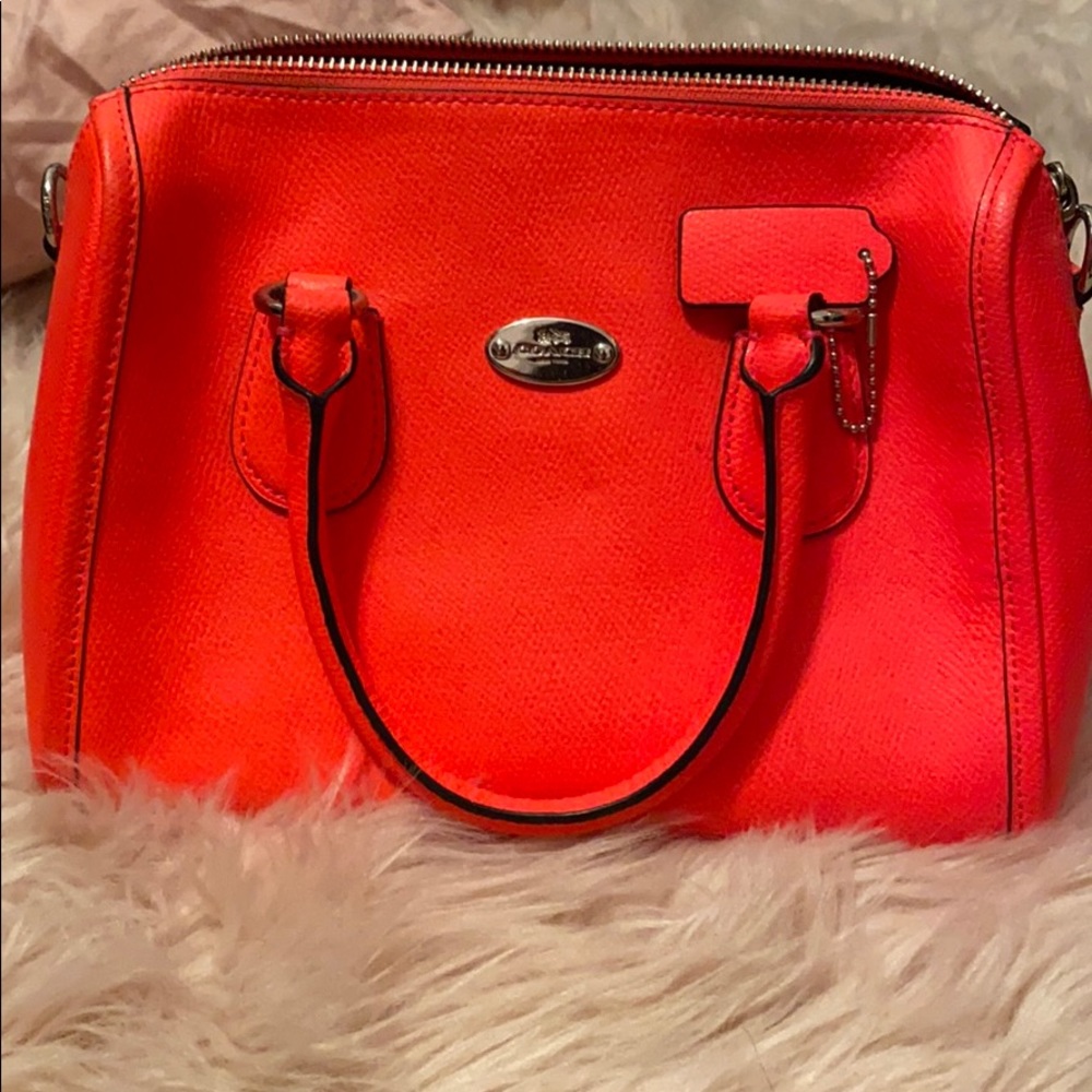 It’s neon pink mini purse -Coach